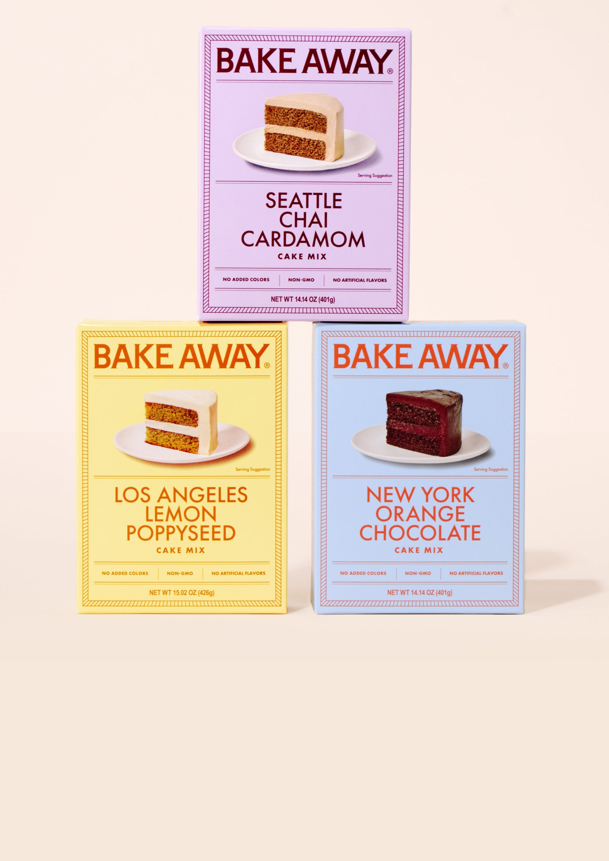 Three 'Bake Away' cake mix boxes on a beige background